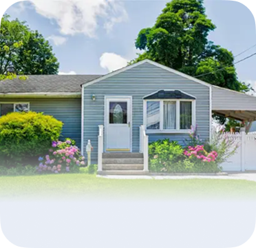 An image of a single-story blue house in Lindenhurst with front steps and garden flowers.