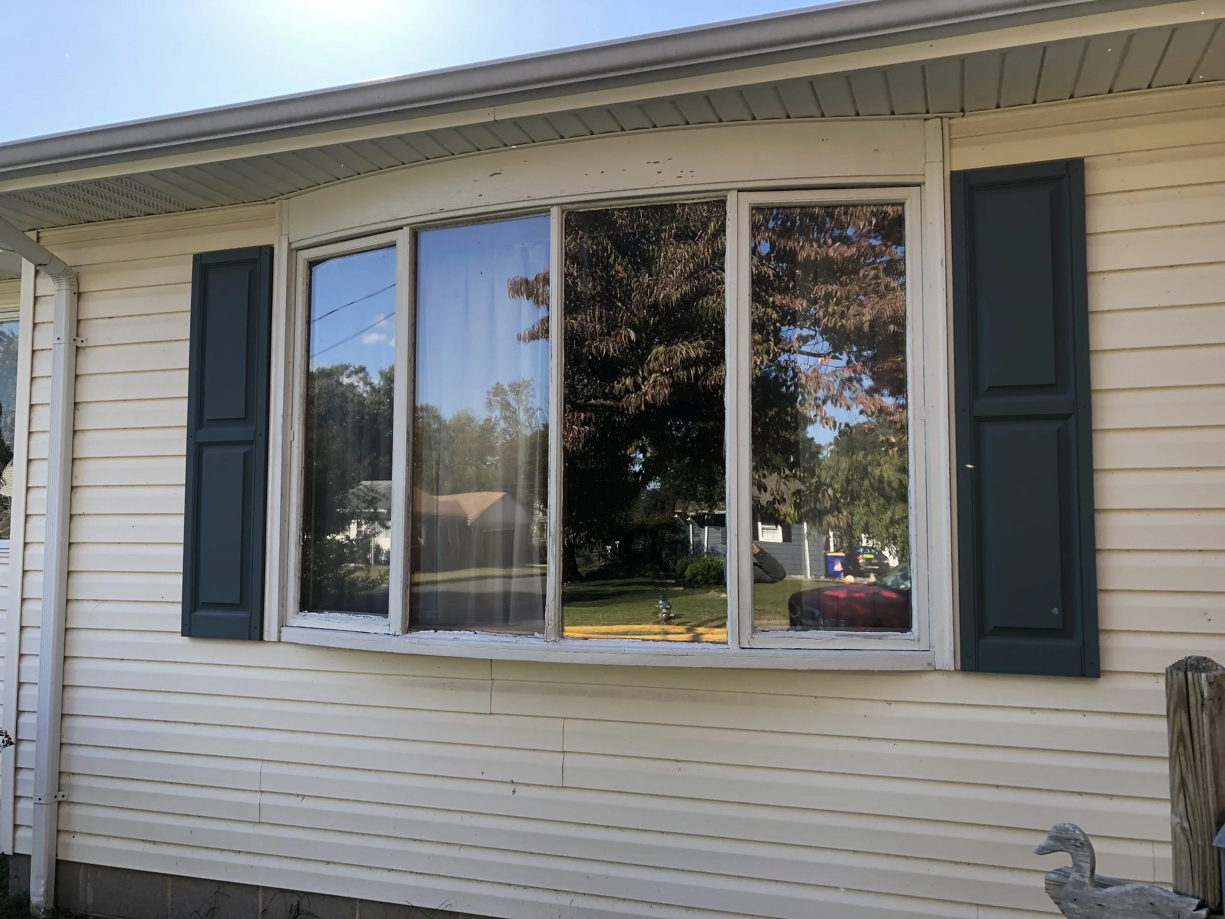 Bay window of rancher style home in need of repair in order to pass home inspection.