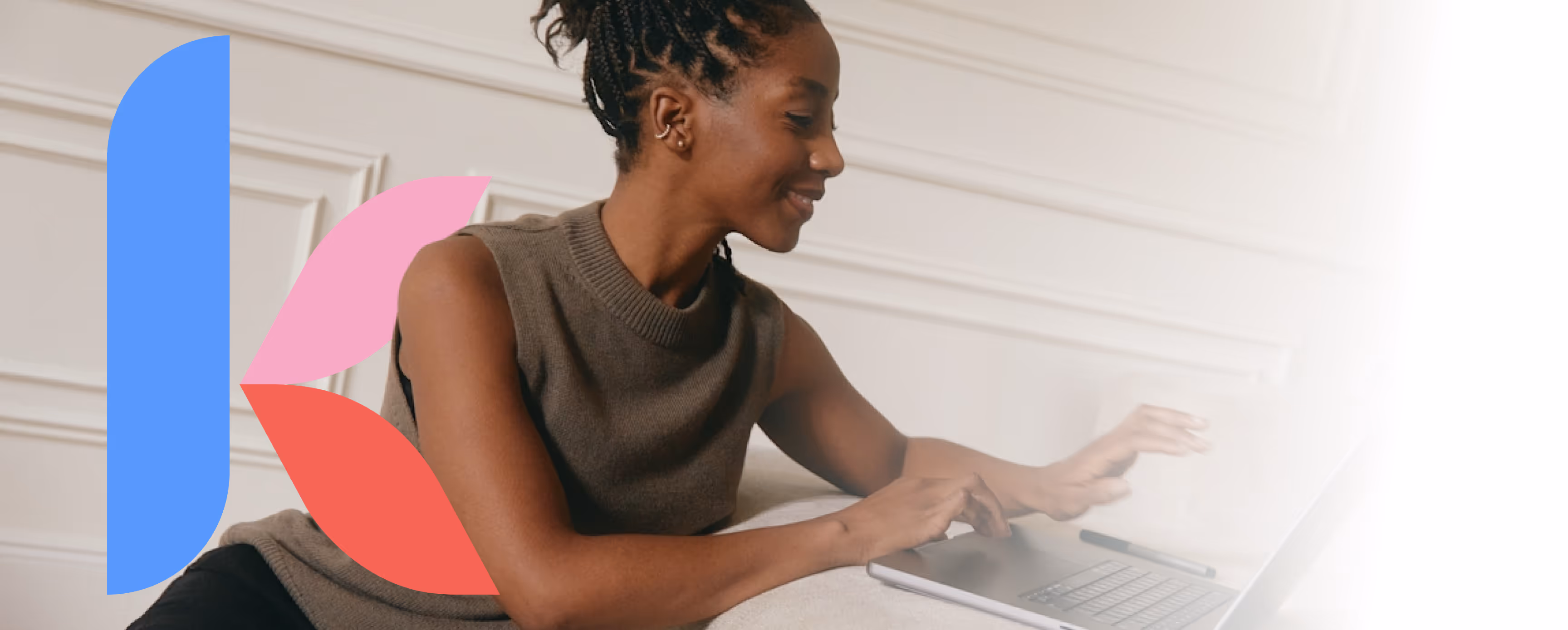 Smiling woman working on a laptop while sitting on a couch. The background features soft lighting and elegant paneling. A large blue and pink leaf-shaped logo element is overlaid on the left, with text on the right that reads ‘See how we’re helping employers’ and a blue button labeled ‘See How It Works.'