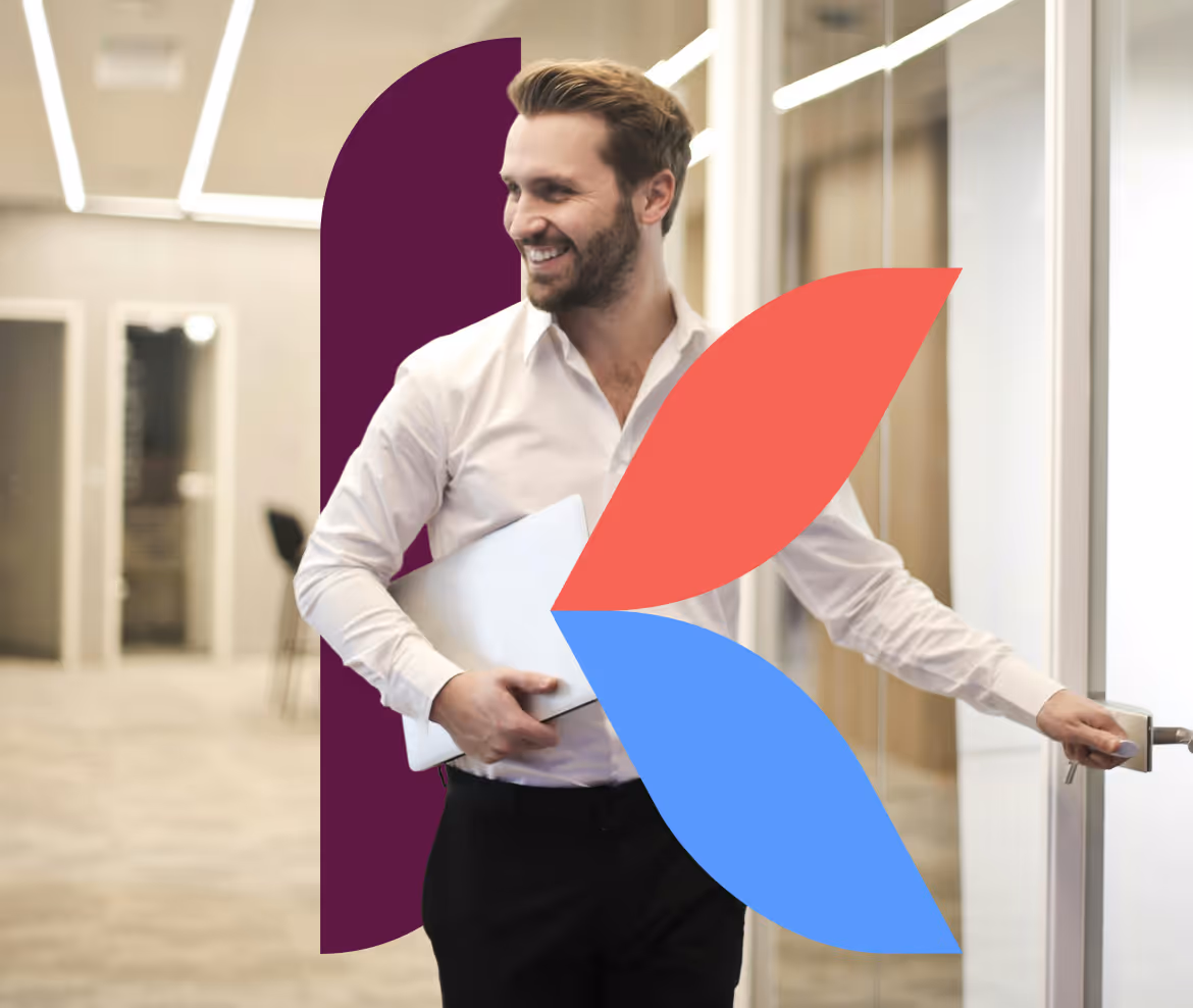 Smiling man in business attire holding a laptop and opening a glass office door. The background shows a modern, well-lit office hallway. Overlaid on the image is a large abstract ‘K’ logo made of maroon, red, and blue leaf-like shapes.