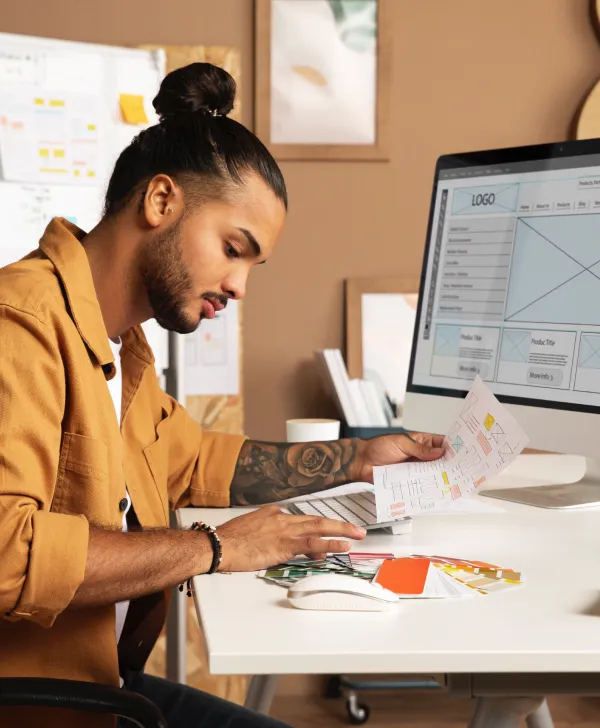A young, professional man working at his imac