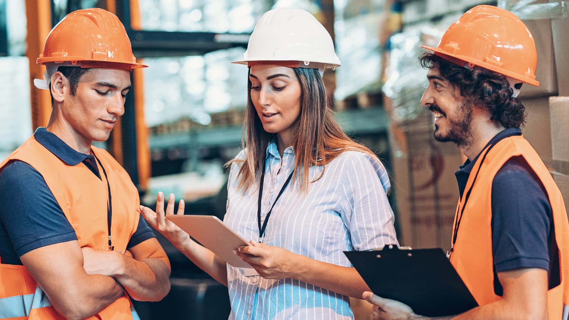A woman user her project-management upskill course learnings at her place or work with. her peers.