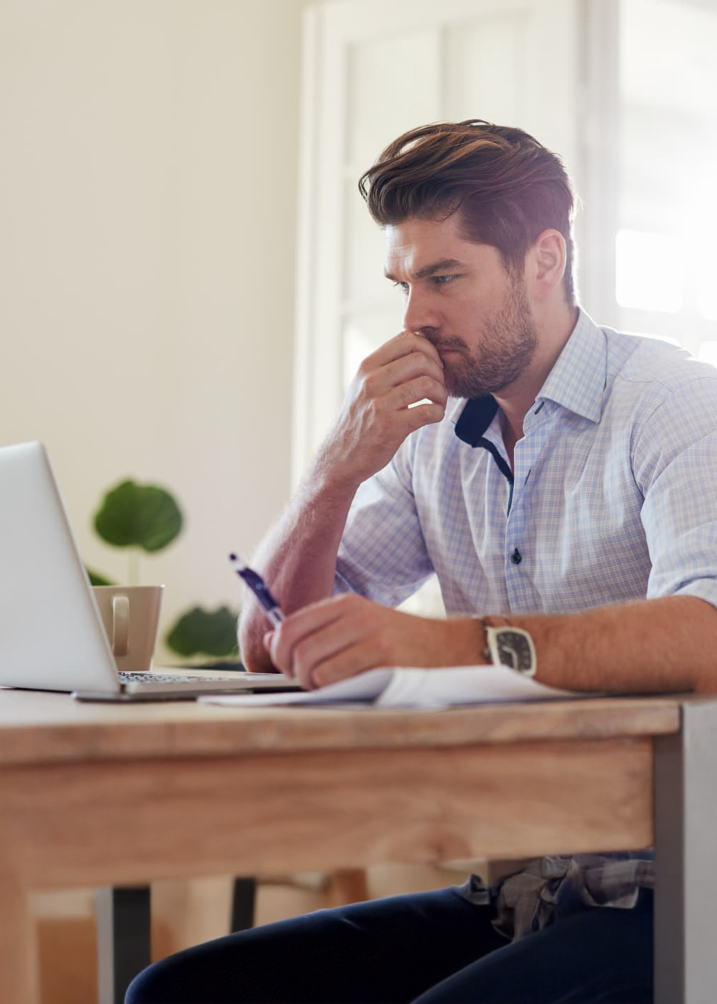 a middle aged professional male studying at a desk.