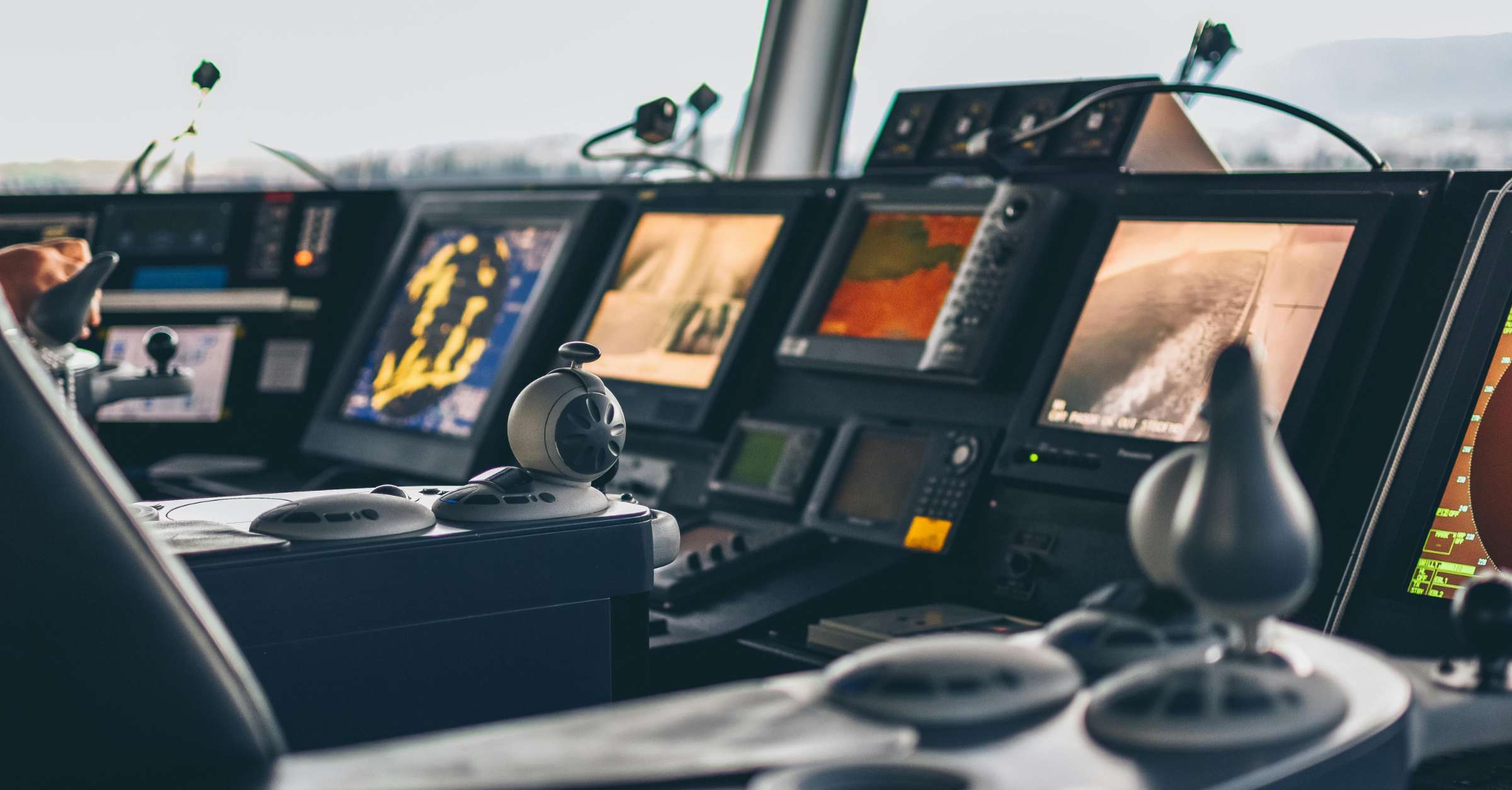 Bridge of a ship with aomputers and navigational equipment.