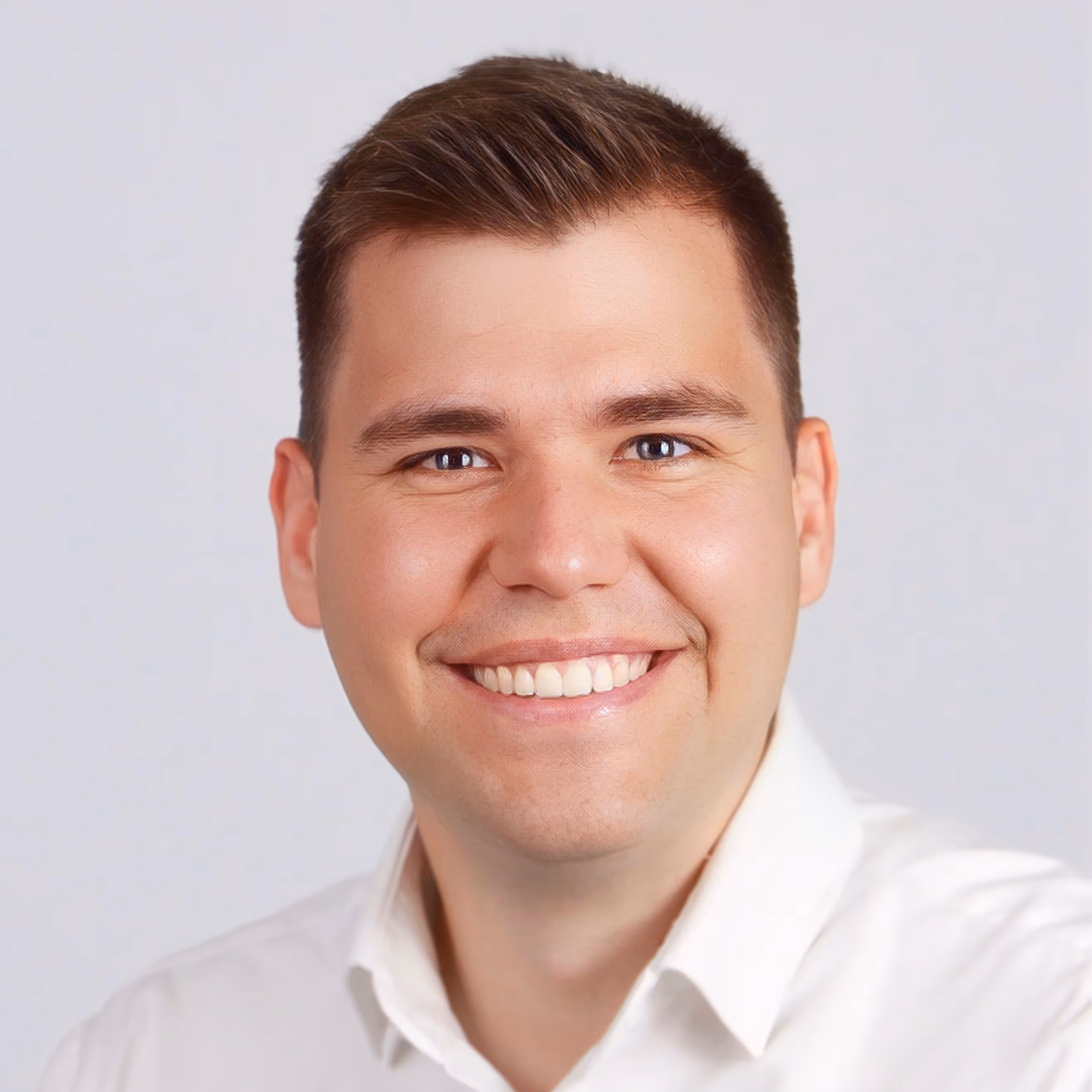 Mann schaut lächelnd in die Kamera