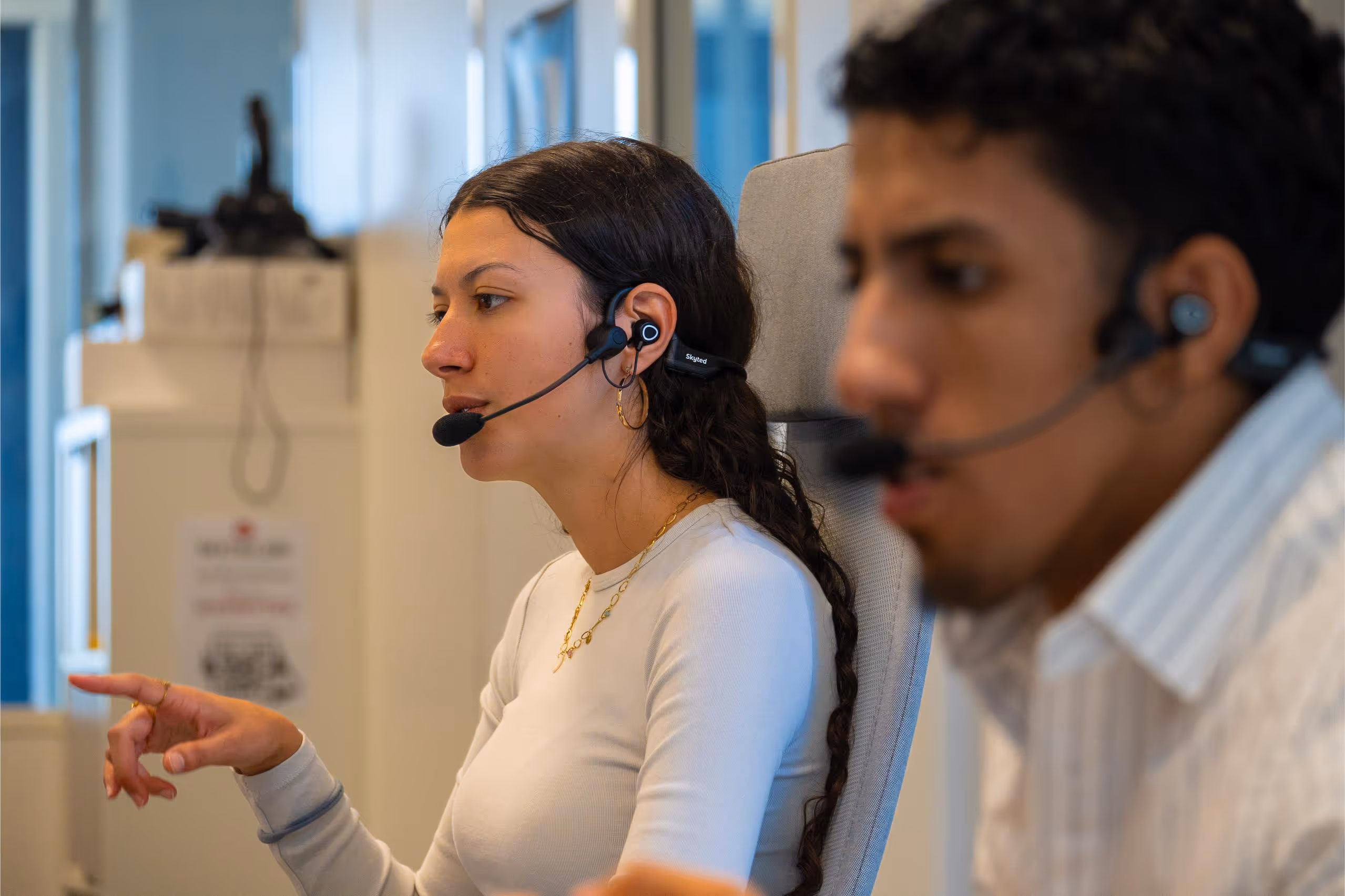 a girl and a guy making a call with skyted 320 in the office