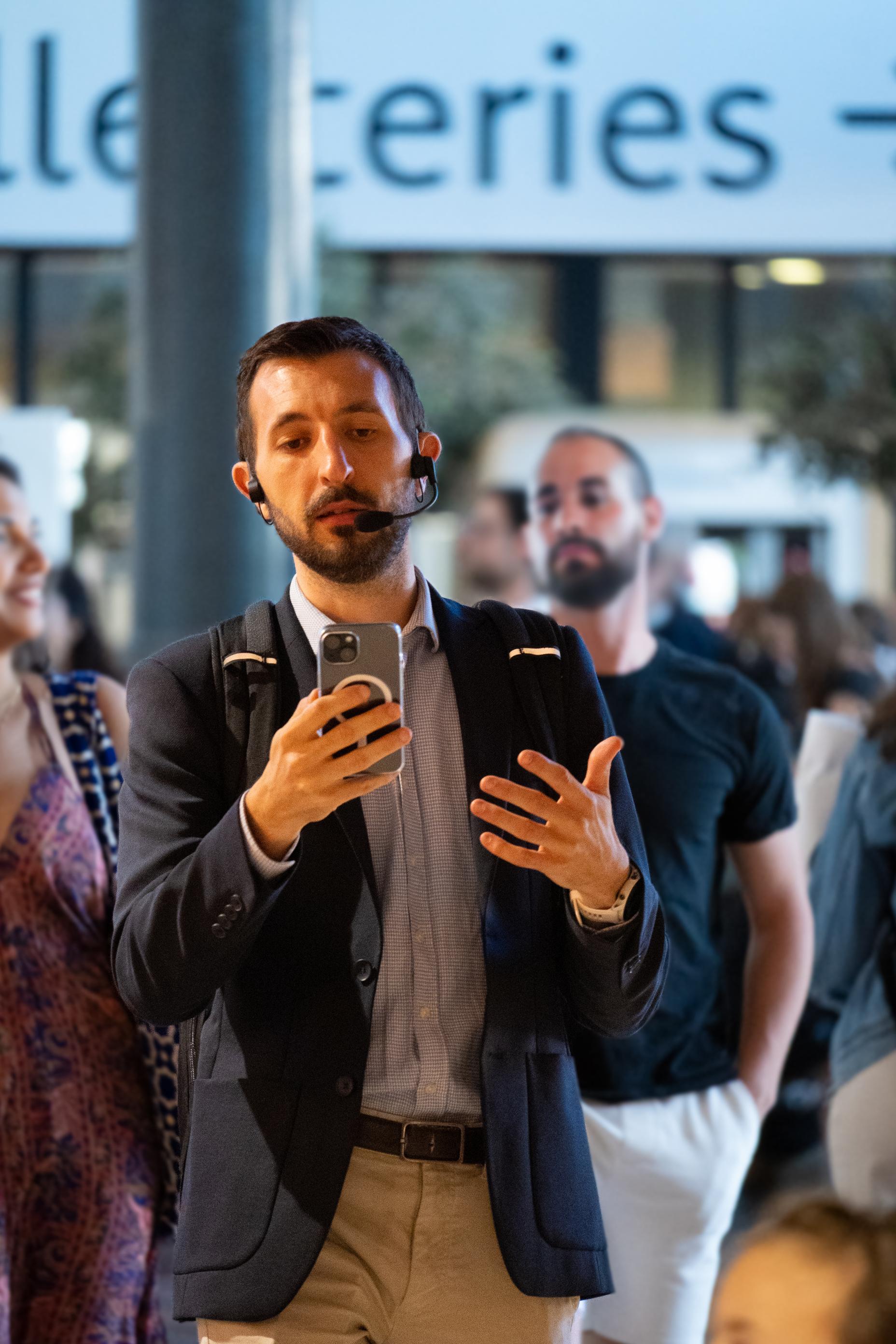 a man talking and using skyted 320 on the street