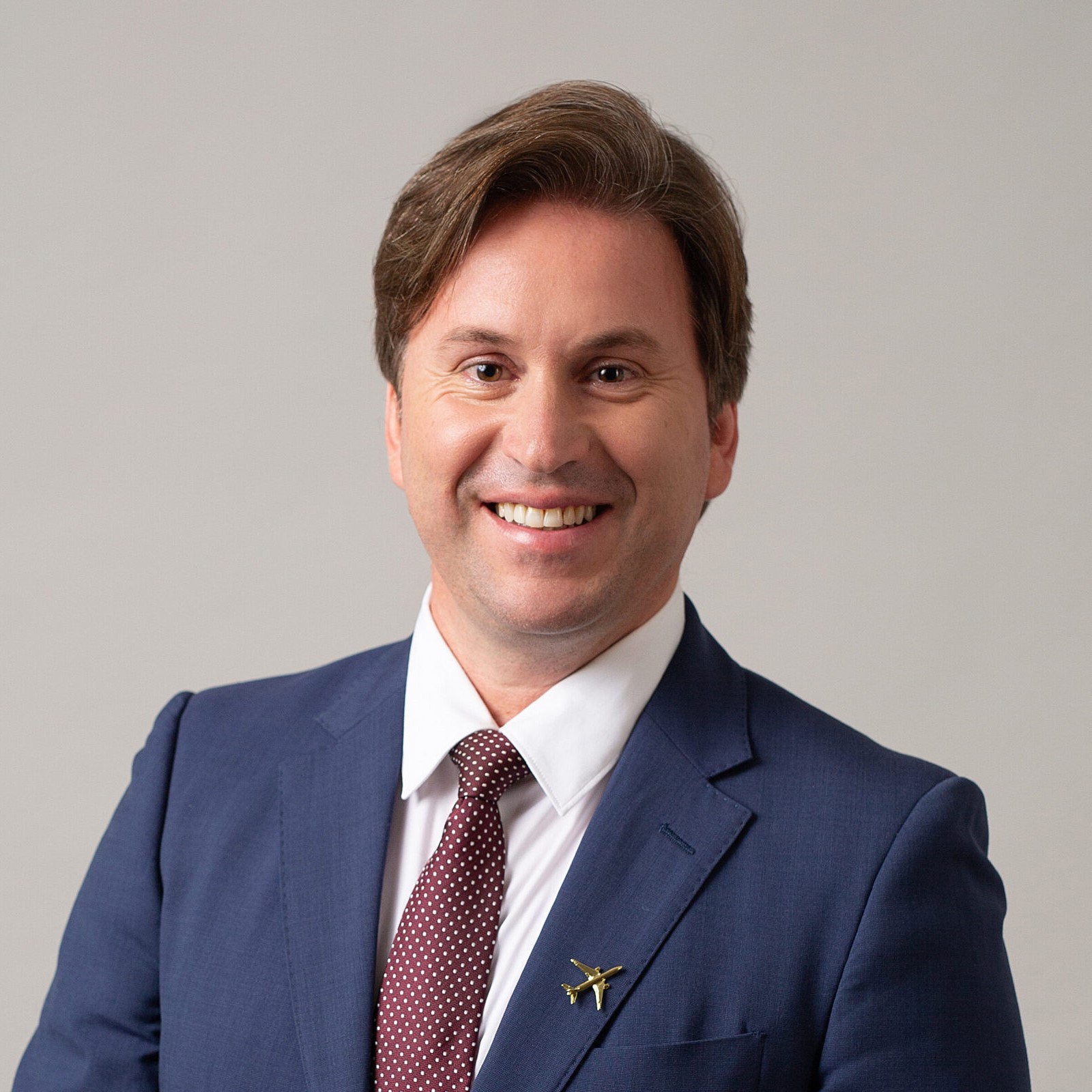 A businessman with a blue suit and a red tie