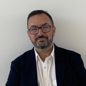 A man with a black suit and white shit