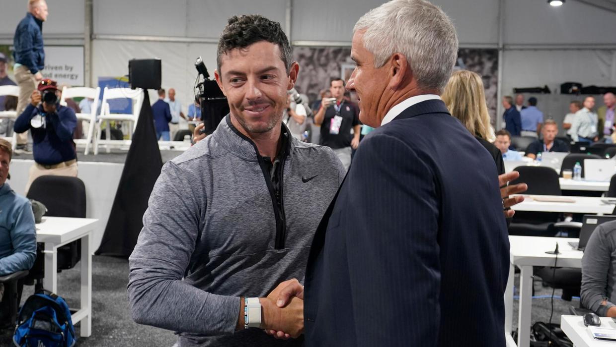 Rory McIlroy shaking hands with Jay Monahan