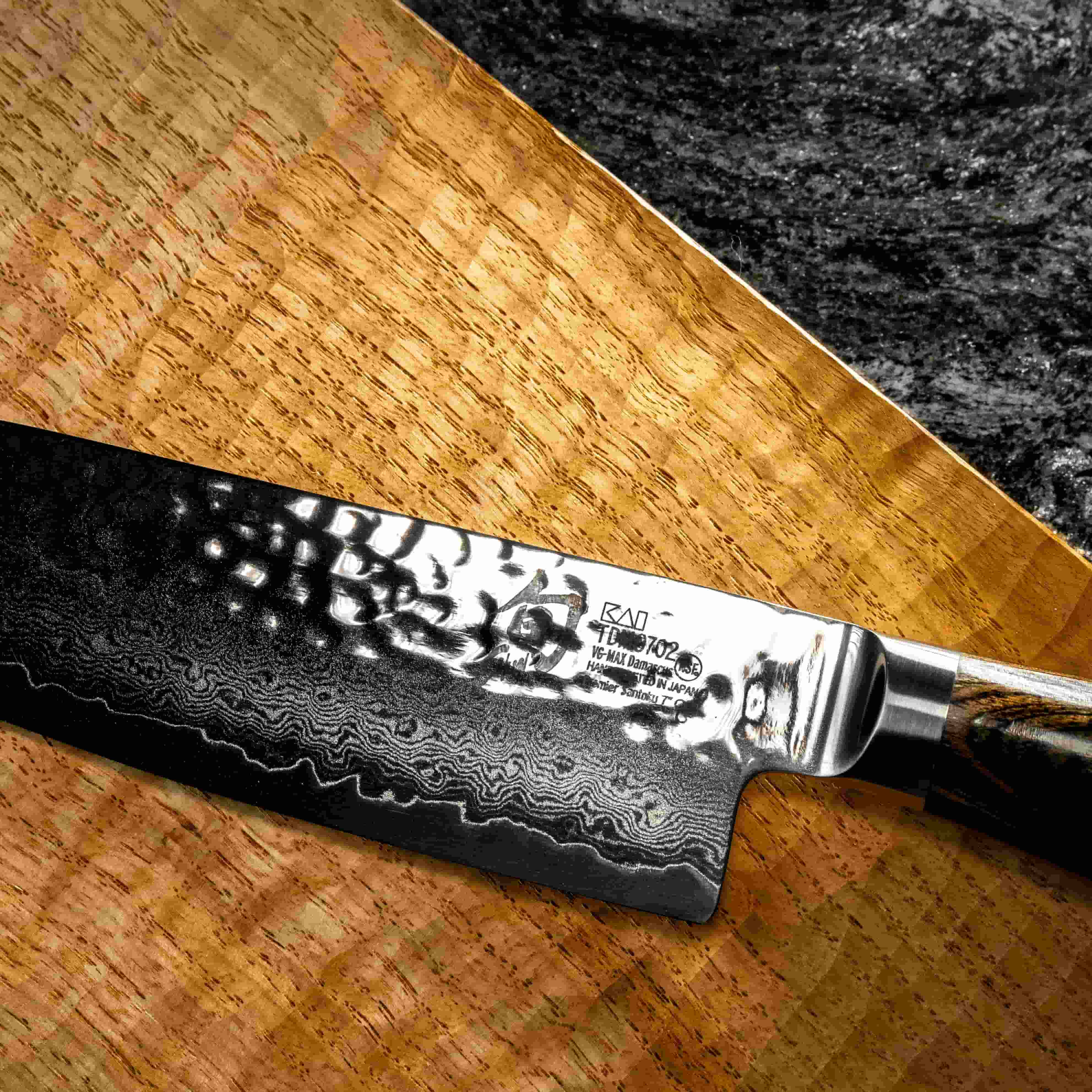 Close up of a hammered shiny kitchen knife.