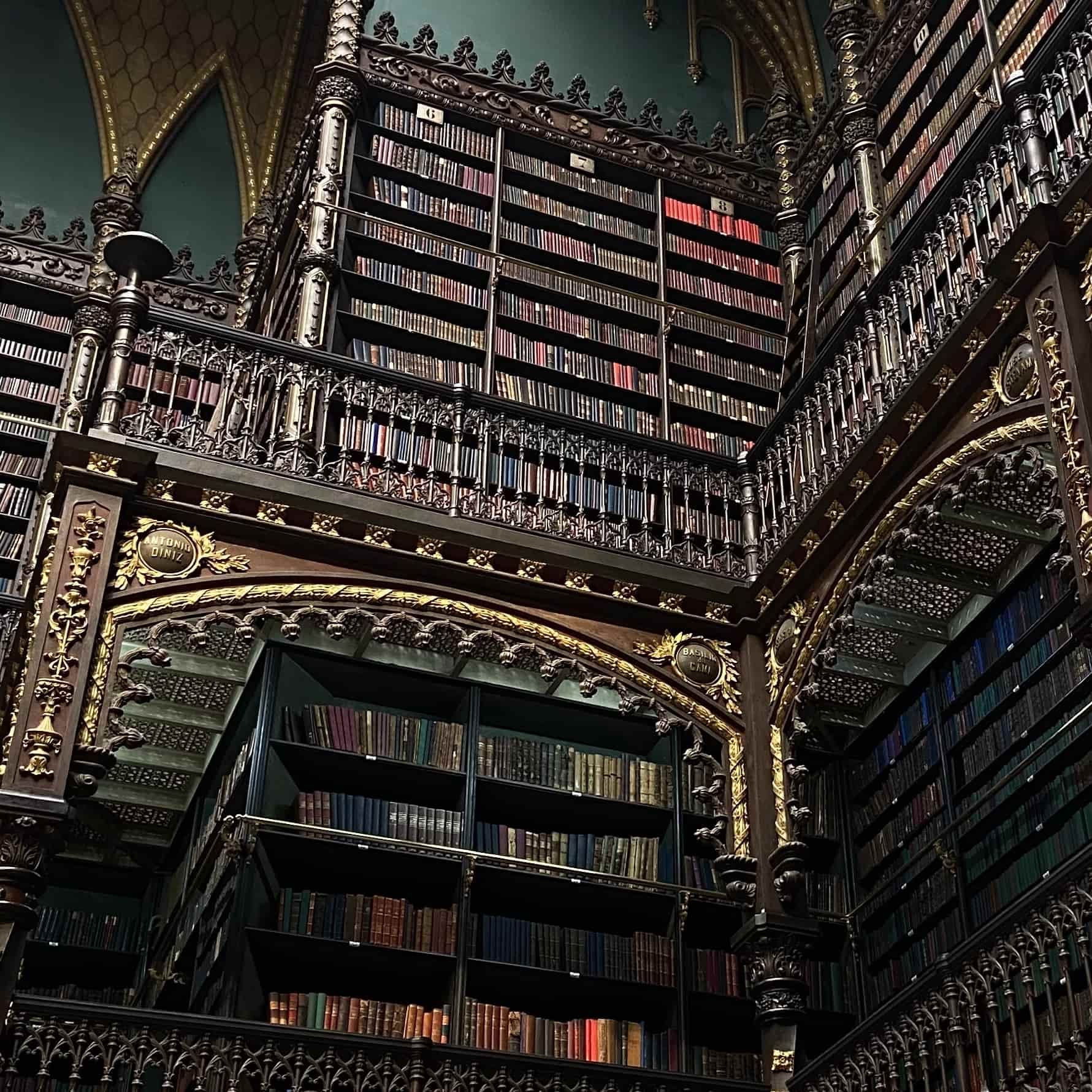 Rows of leatherbound books in an old dark wood library.