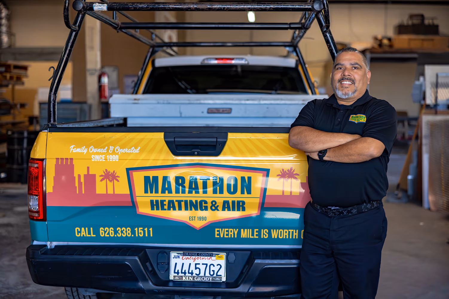 Marathon tech standing in front of car