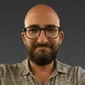 Headshot of Johannes Pfeiffer with glasses and a beard, illustrating his expertise in technical strategy.