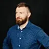 Headshot of Sergiej Soft Rewiakin wearing a blue shirt, conveying his expertise in software development.