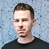 Portrait of Nikolai Gulatz in front of a network-patterned background, highlighting his role as a tech advisor.