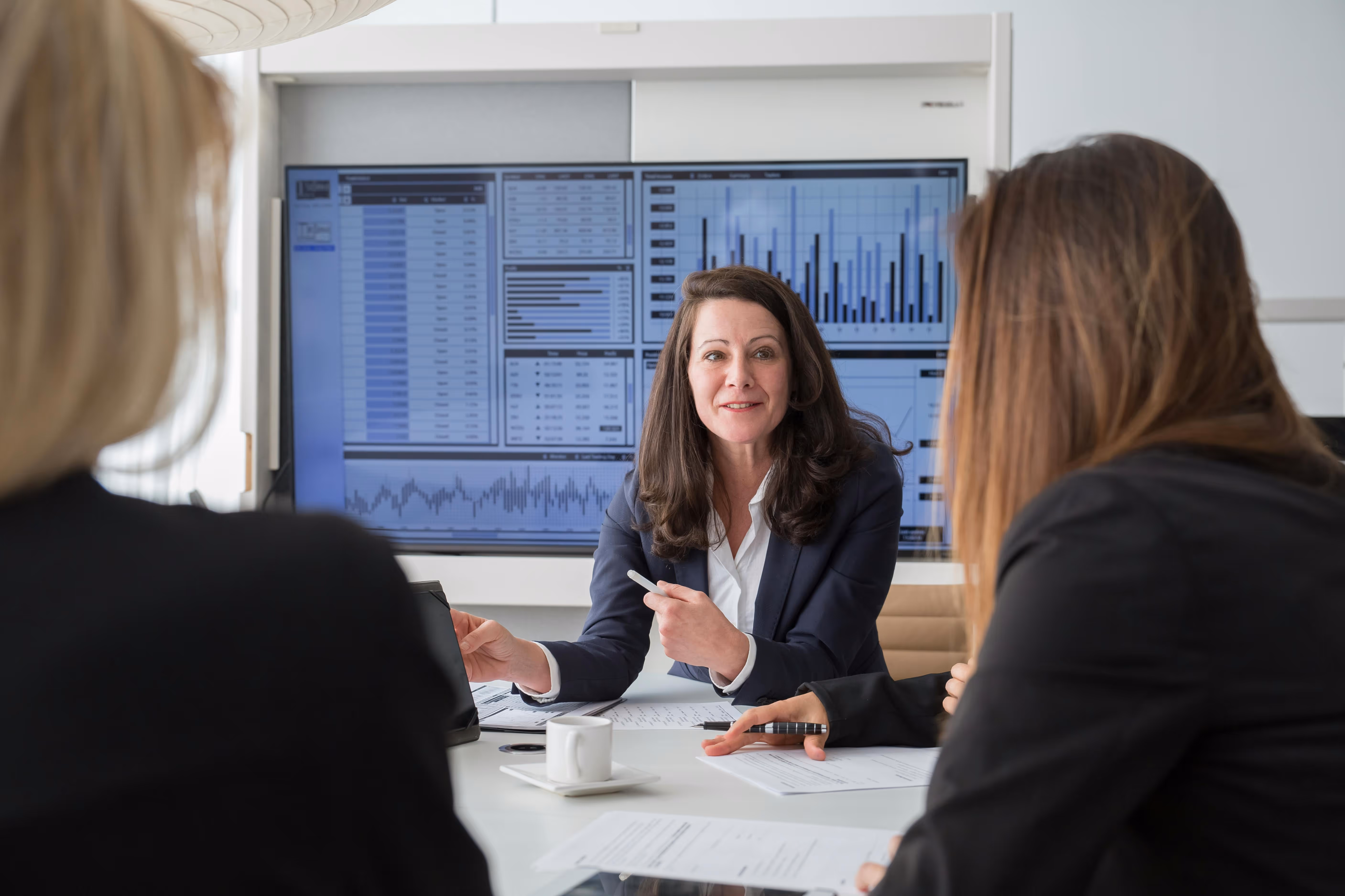 Woman in a suit presenting data