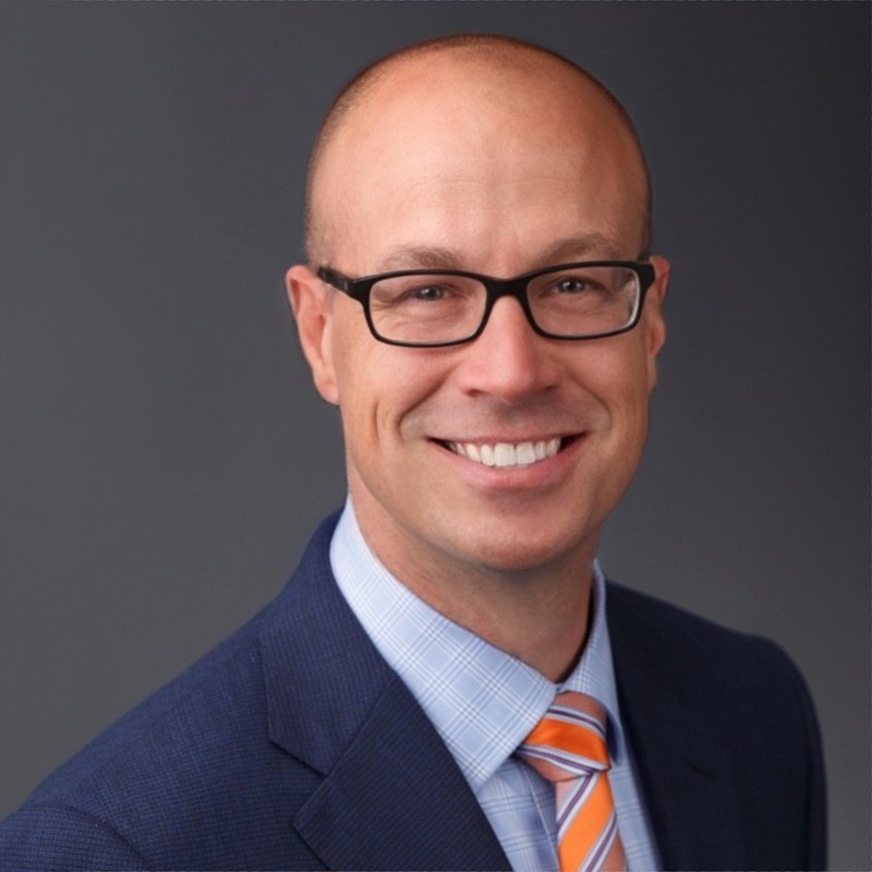 Jacob Jessen in suit smiling at the camera