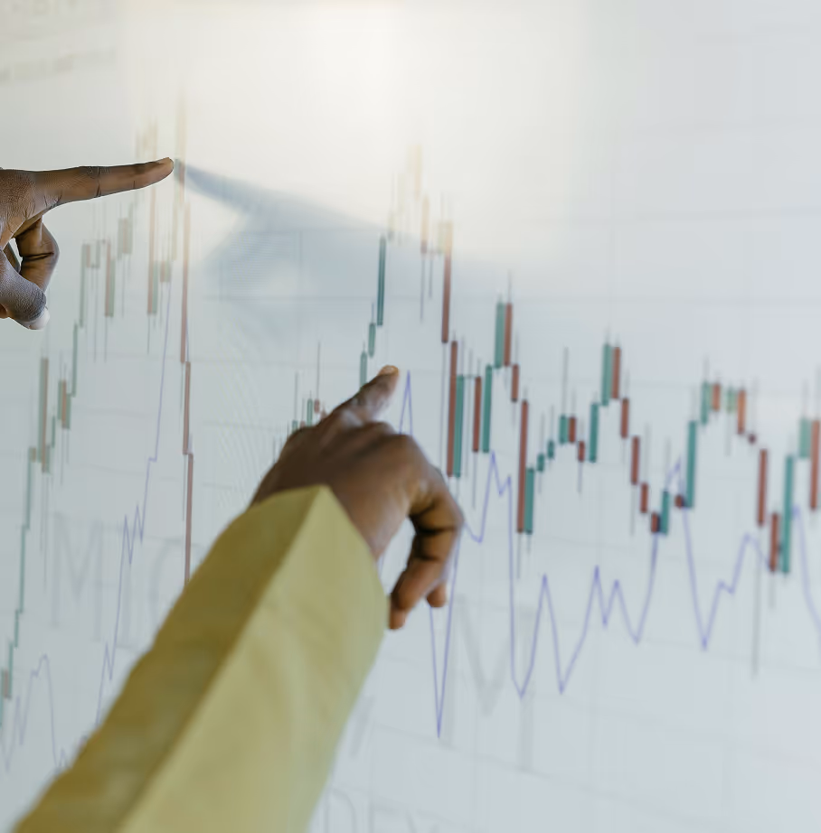 Hands pointing at stock market charts