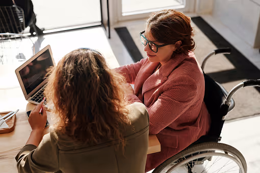 Disabled leader discussing strategy with a colleague