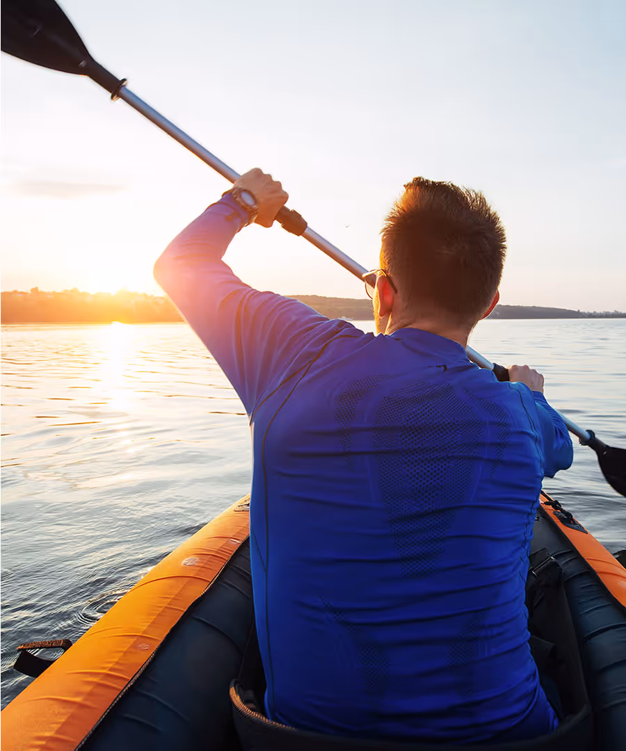 A man kayaking in New Hampshire Lake