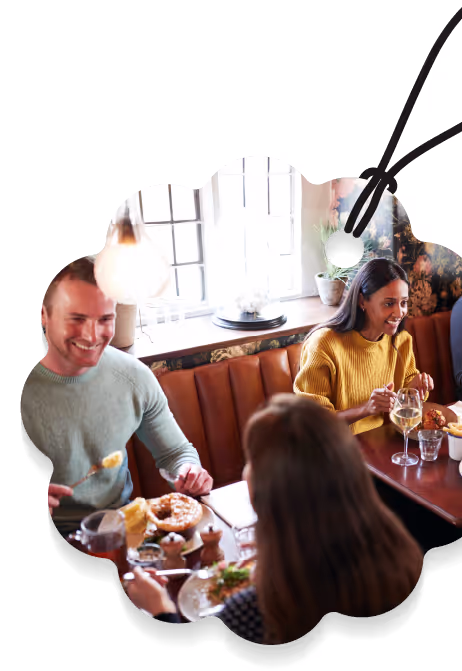 a group of people eating at a restaurant