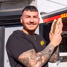 a man holding a hot dog
