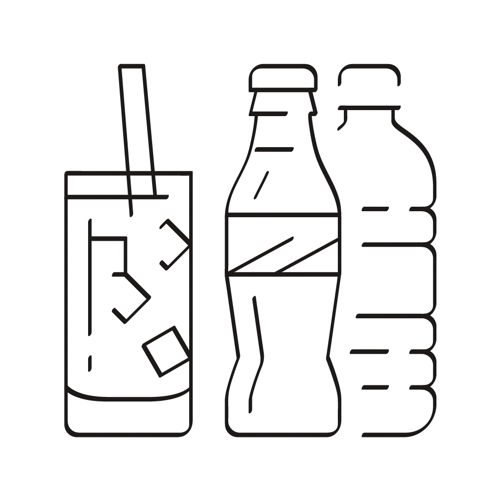 A glass with ice and a straw next to two beverage bottles