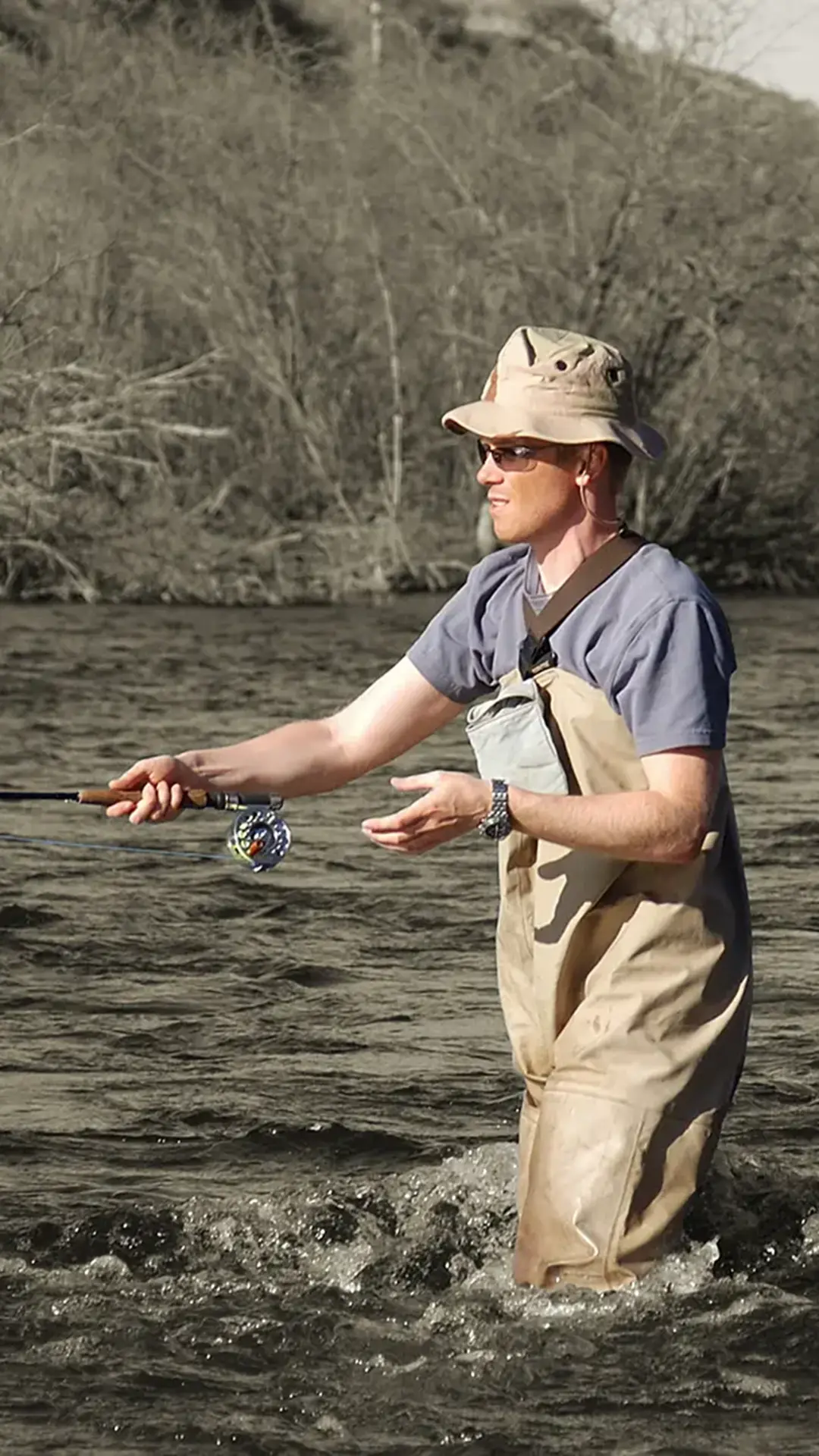 Man fly fishing in a mountain stream, showcasing outdoor recreation near Alcove luxury townhomes in Midway, Utah