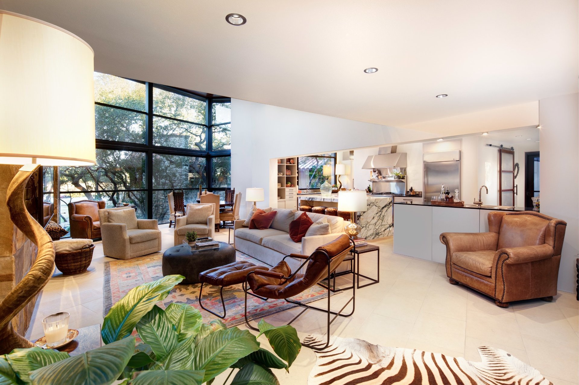 Open-concept living room with floor-to-ceiling windows in a modern Austin custom home.
