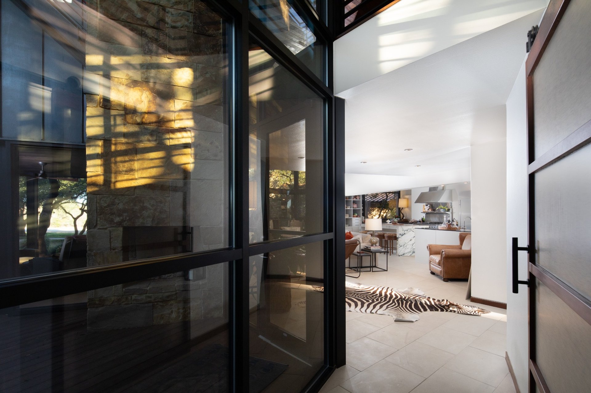 Entryway view into an open-concept modern home with natural light and custom finishes.