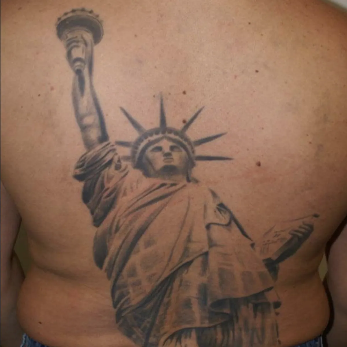 Tattoo of the Statue of Liberty covering a person's back.