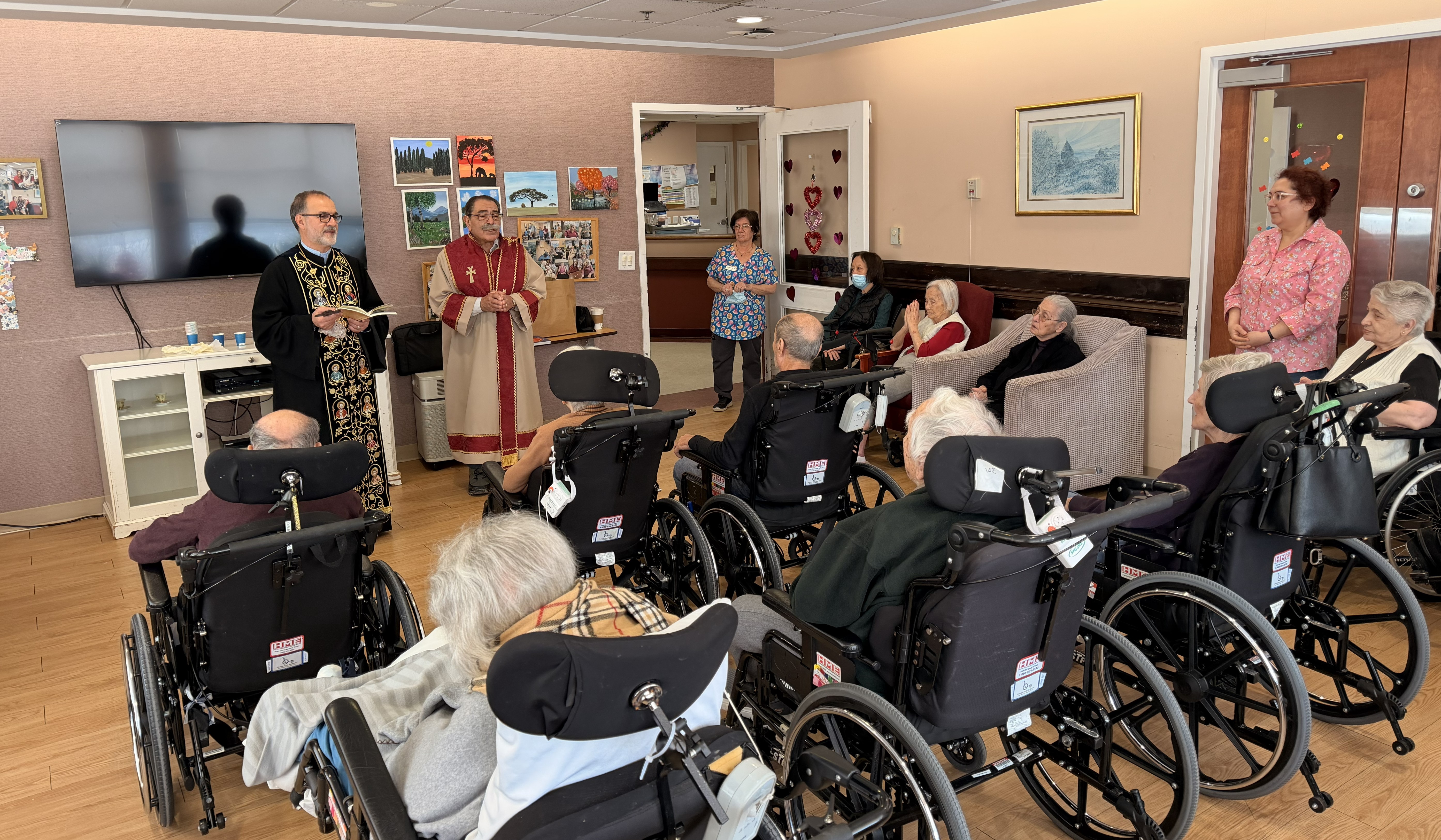 A funeral wreath of pink and white flowers with a ribbon reading “FROM VARTAN VARTANI AND FAMILY” inside Holy Trinity Armenian Church