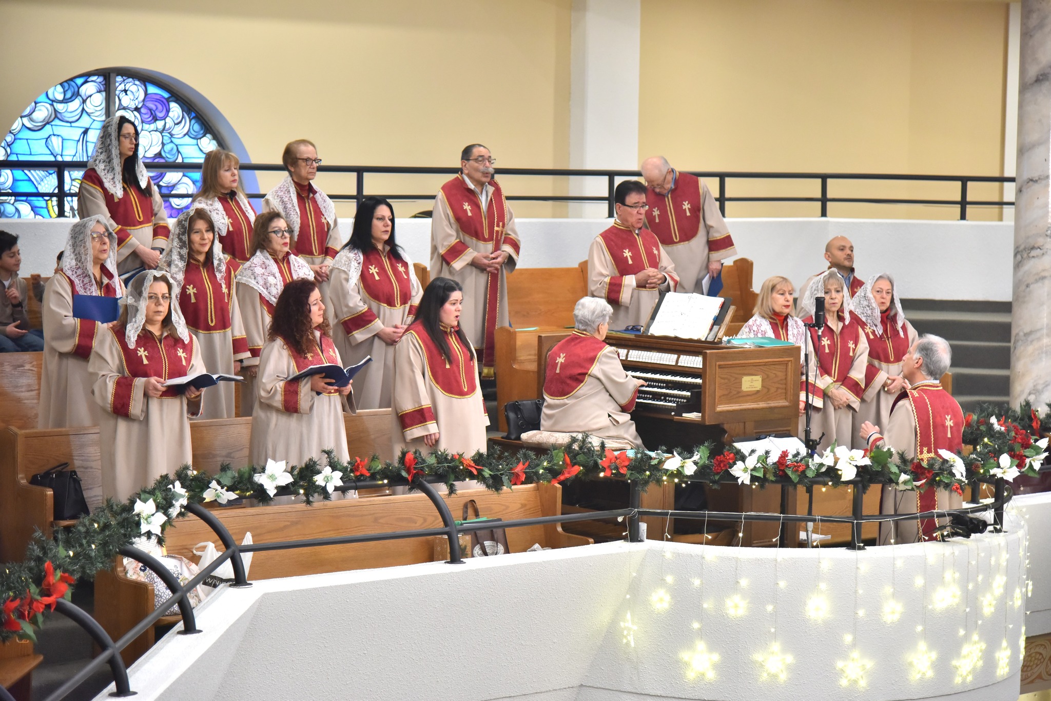 A funeral wreath of pink and white flowers with a ribbon reading “FROM VARTAN VARTANI AND FAMILY” inside Holy Trinity Armenian Church