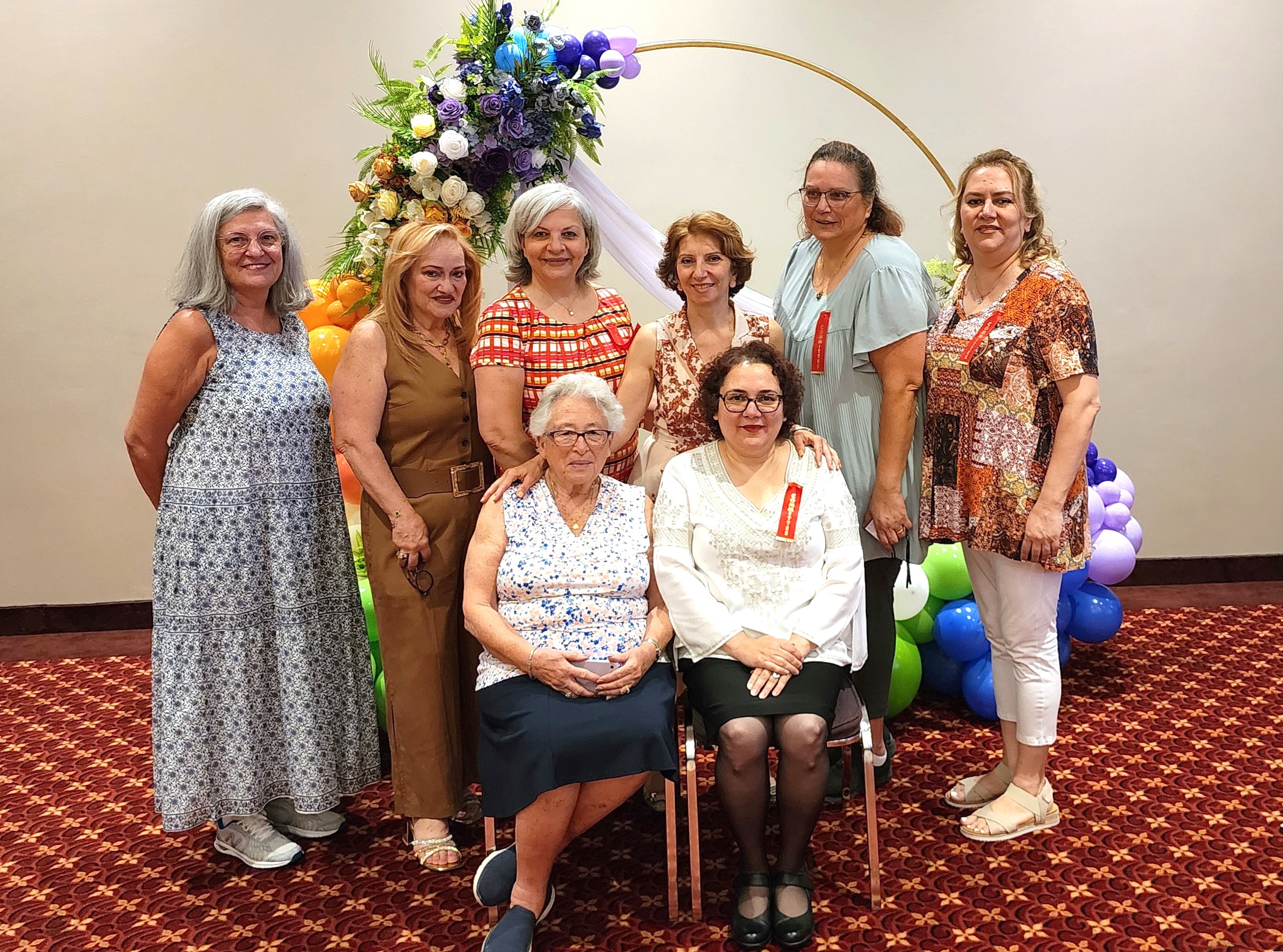 A funeral wreath of pink and white flowers with a ribbon reading “FROM VARTAN VARTANI AND FAMILY” inside Holy Trinity Armenian Church