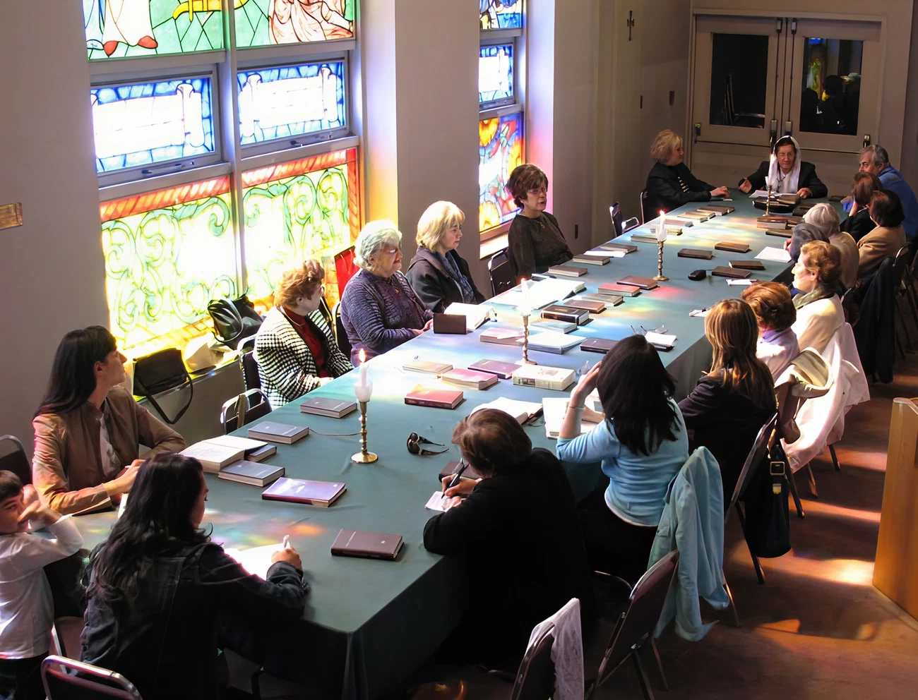 A funeral wreath of pink and white flowers with a ribbon reading “FROM VARTAN VARTANI AND FAMILY” inside Holy Trinity Armenian Church