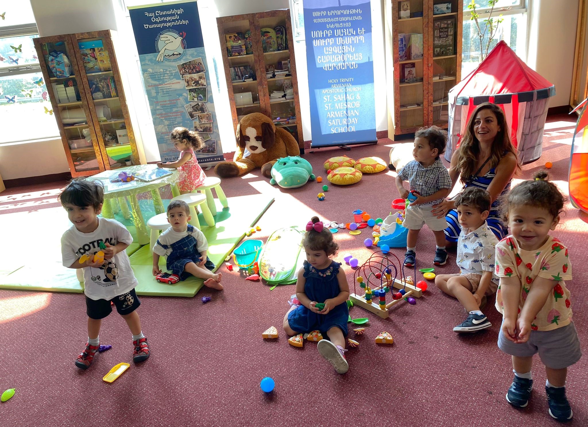 A funeral wreath of pink and white flowers with a ribbon reading “FROM VARTAN VARTANI AND FAMILY” inside Holy Trinity Armenian Church