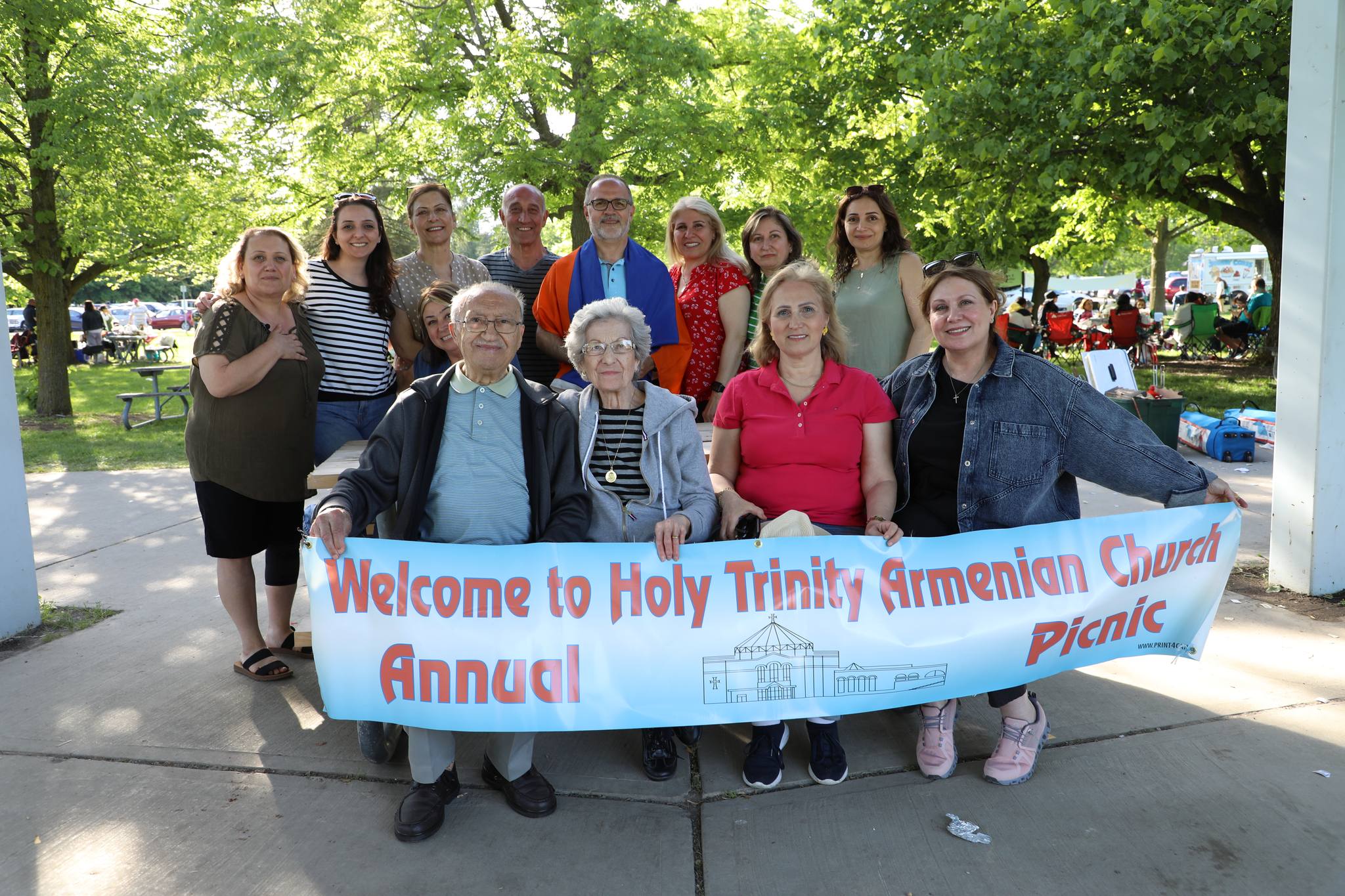 A funeral wreath of pink and white flowers with a ribbon reading “FROM VARTAN VARTANI AND FAMILY” inside Holy Trinity Armenian Church