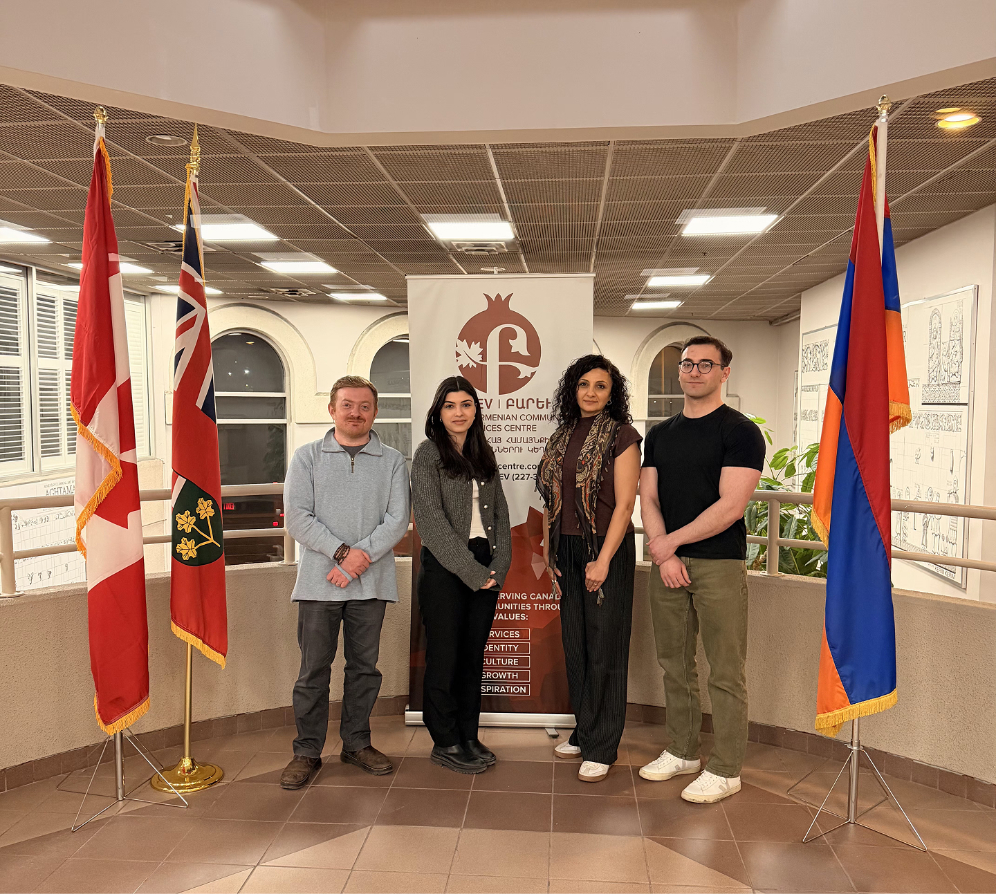 A funeral wreath of pink and white flowers with a ribbon reading “FROM VARTAN VARTANI AND FAMILY” inside Holy Trinity Armenian Church