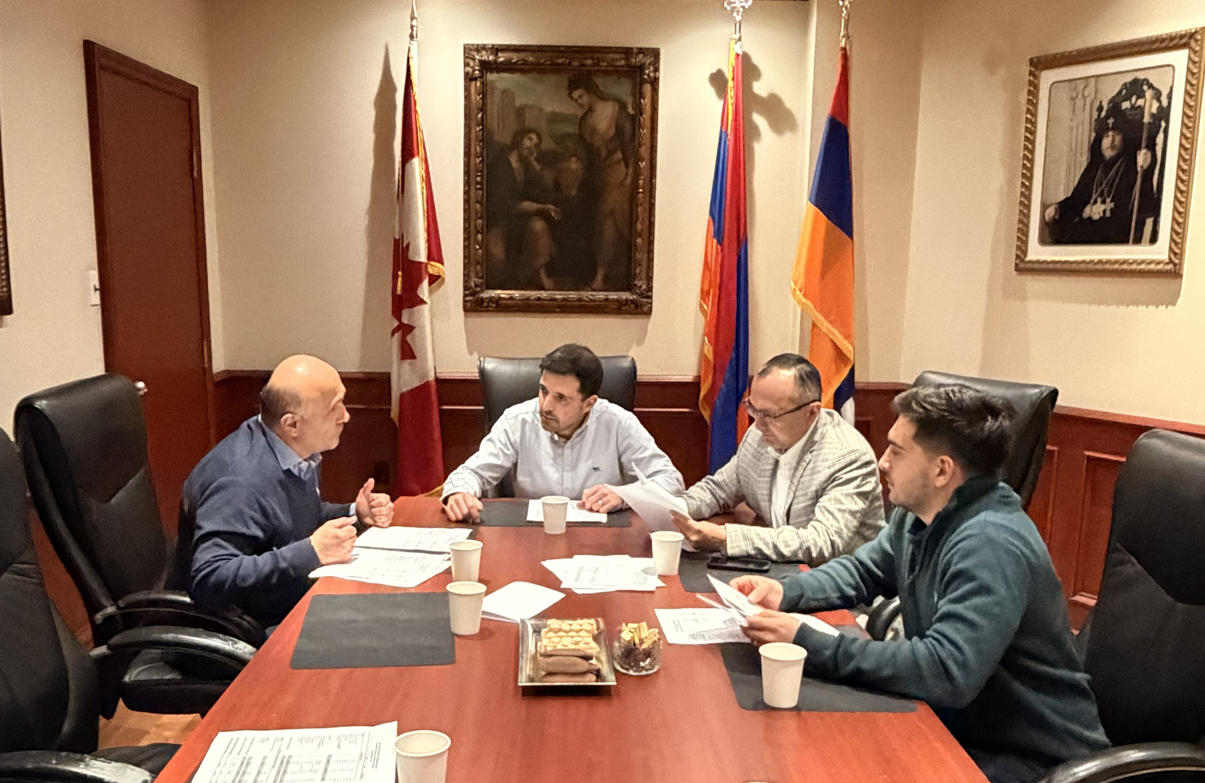 A funeral wreath of pink and white flowers with a ribbon reading “FROM VARTAN VARTANI AND FAMILY” inside Holy Trinity Armenian Church