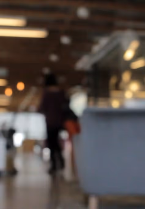 Blurred Tribevest office interior with people and warm lighting