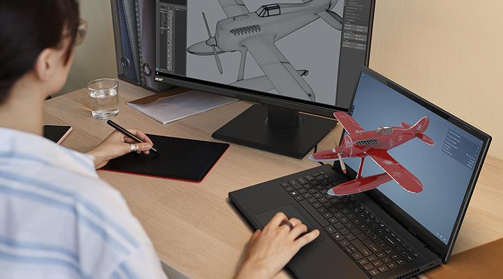 Designer working on a plane model design with tablet, porting the 3D projection to the laptop