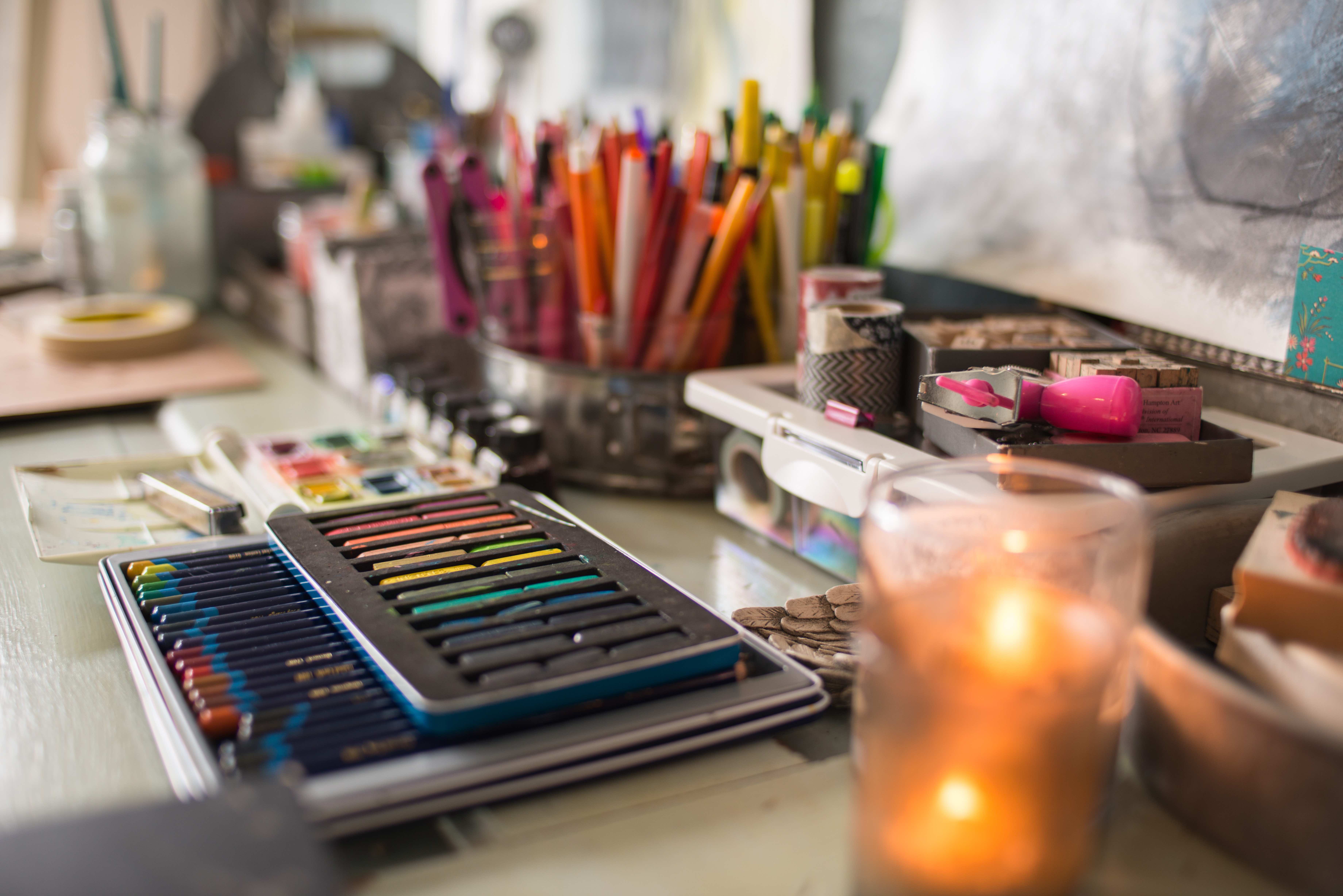 Paint, brushes and a journal laid out for class