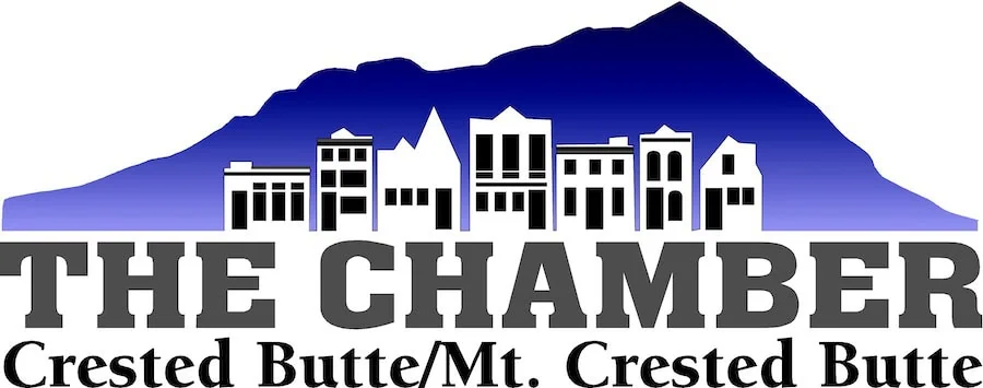 Logo with blue mountain silhouette above black and white town buildings and text The Chamber Crested Butte/Mt. Crested Butte.