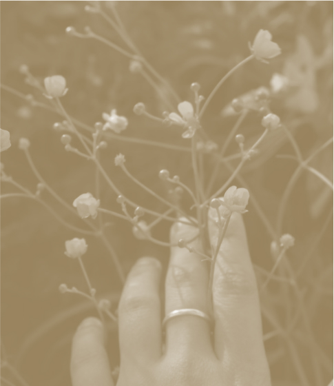Close up image of someone cupping  their ear to hear better with a sepia filter