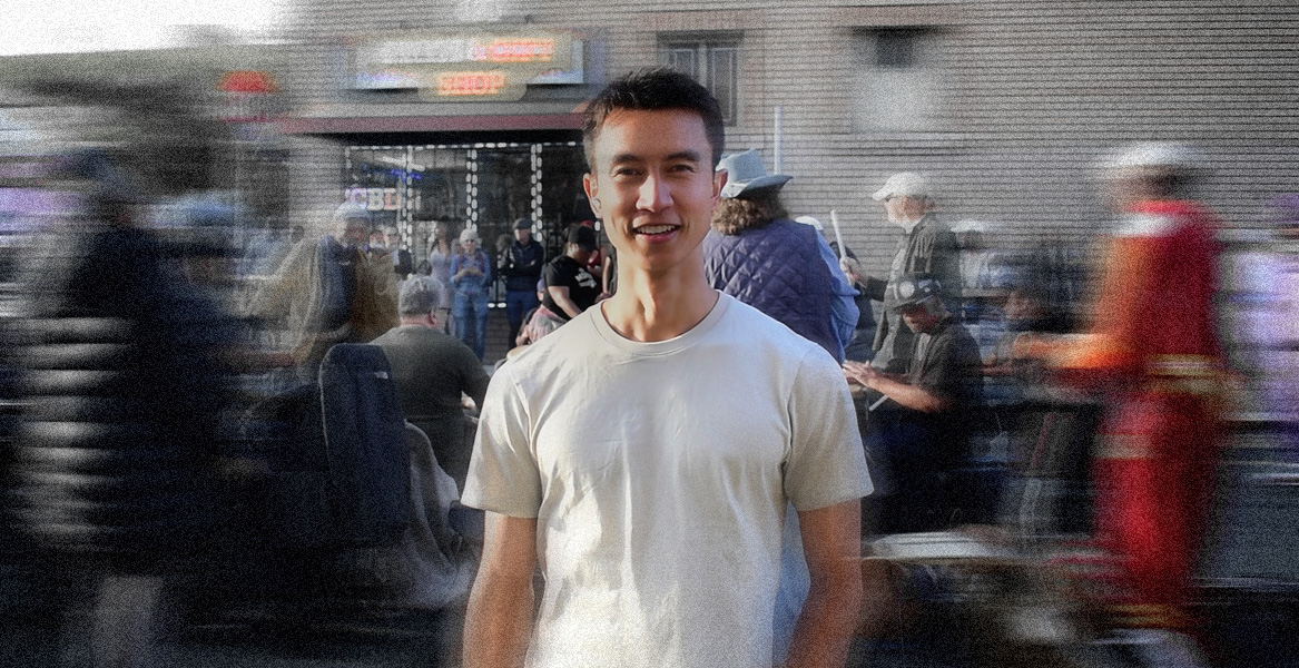 Image of Subtle CEO standing in front of musicians playing at an outdoor festival.  Image background is blurred.