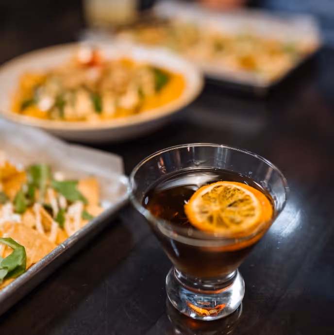 An old fashioned cocktail with a mandarin slice