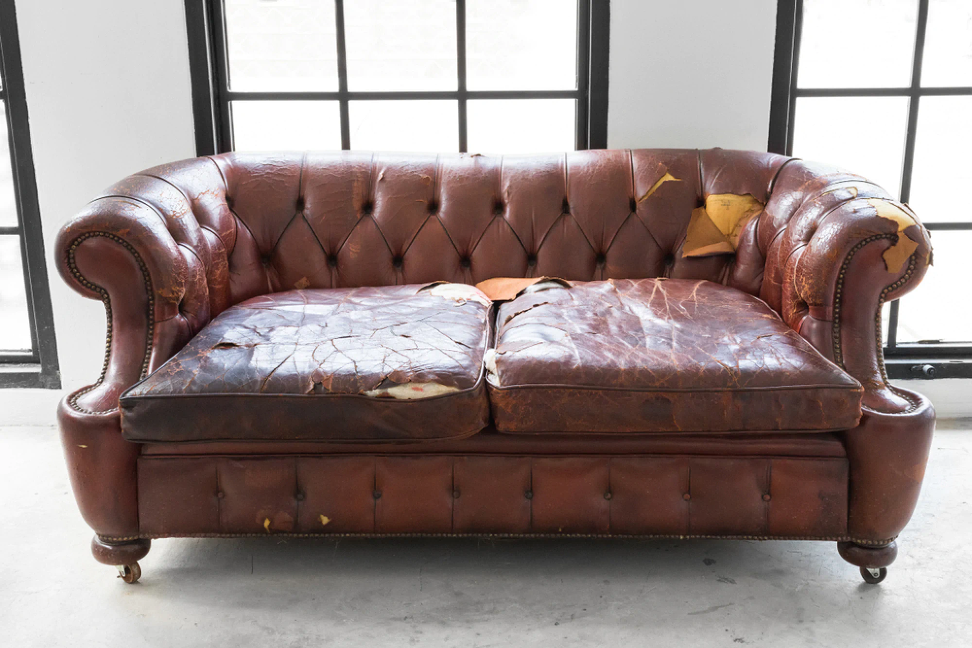 Worn down leather brown couch