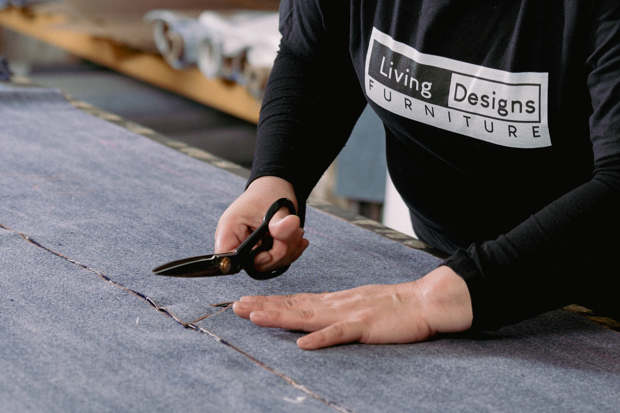 Living Designs Furniture factory worker cutting fabric