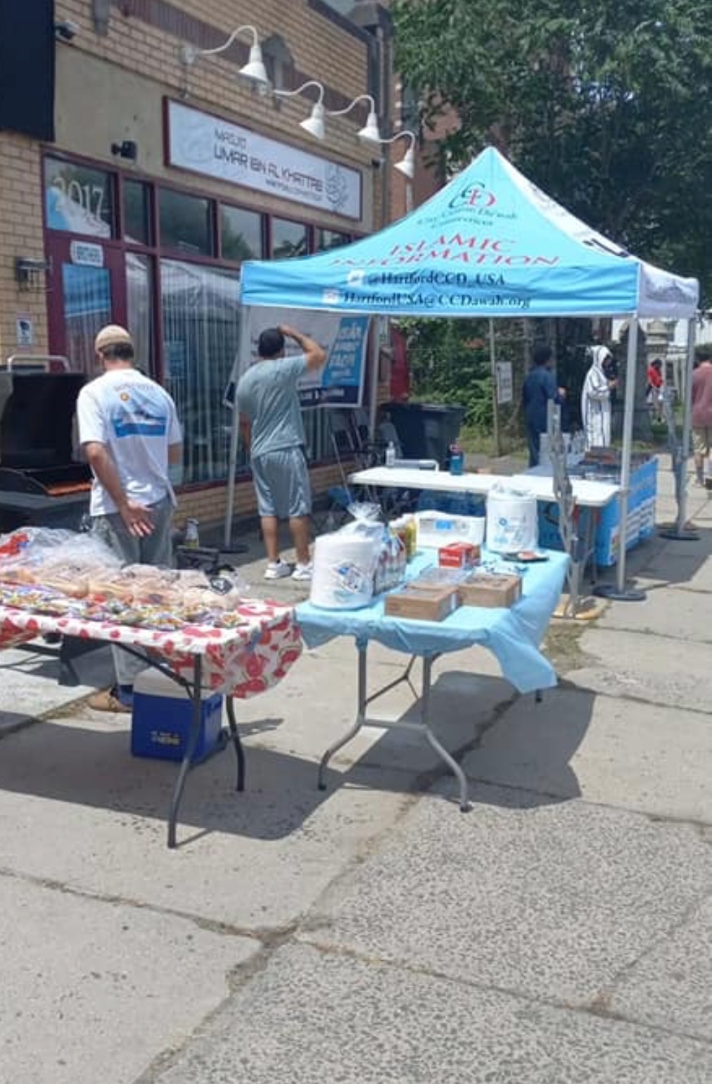 Community members serving food and engaging with the public outside Masjid Umar ibn Al-Khattab in Hartford, Connecticut.